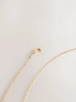 Tonalité d'or - Collier avec pendentif détail fleuri